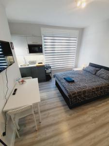 a bedroom with a bed and a table in it at Southend on Sea - Westcliff Studios - Great Location in Southend-on-Sea