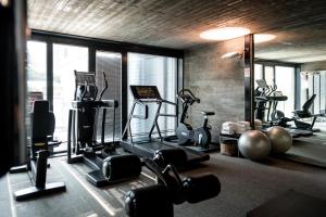 a gym with weights and exercise equipment in a room at Duparc Contemporary Suites in Turin