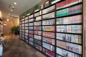 a wall of video games in a store at Tabist Hotel Smart Sleeps Oita Station in Oita