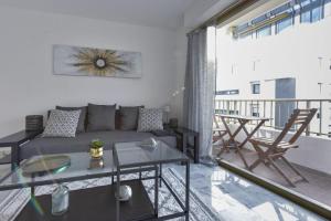 a living room with a couch and a table at SERRENDY Cannes Palm Beach 2min walk to beaches in Cannes