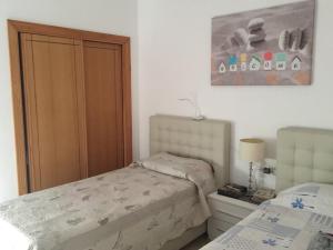 a bedroom with a bed and a closet and a bed at Casa Tortuga in Caleta De Fuste