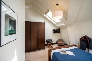 a bedroom with a blue bed and a cabinet at Astoria Hotel in Lviv