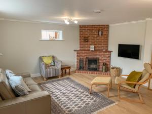 a living room with a couch and a fireplace at The Cottage in Salisbury