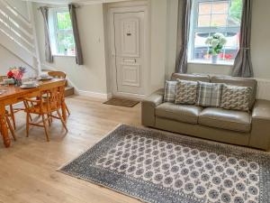 a living room with a couch and a table at The Cottage in Salisbury