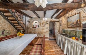 a kitchen with a long counter with fruits on it at House Peresiji in Peresiji