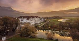 a large white building next to a river at Prestige Harbourfront Resort, WorldHotels Luxury in Salmon Arm