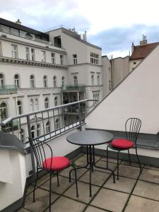 a table and two chairs sitting on a balcony at Apartments near Rathaus in Vienna