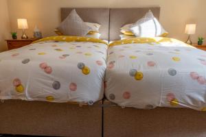 a bed with two pillows on top of it at Highgate View Apartment in Kendal
