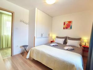 Postel nebo postele na pokoji v ubytování Jasmina Apartment