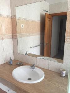 a bathroom with a sink and a mirror at Casa Tortuga in Caleta De Fuste