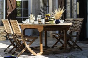 una mesa de madera con 2 sillas alrededor en Le Riad Bourguignon, en Ouanne