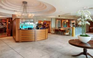 a large room with a counter and a table at Green Isle Hotel, Dublin in Clondalkin