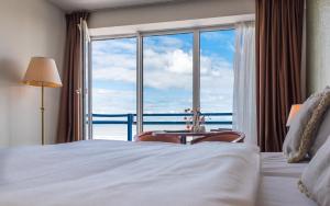 Postel nebo postele na pokoji v ubytování Prominent Inn Hotel