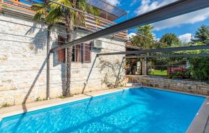 a swimming pool in the backyard of a house at House Peresiji in Peresiji