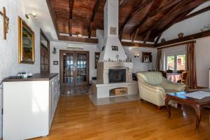 a living room with a fireplace and a table at Apartments Školjka in Rijeka