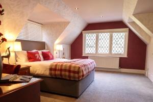 A bed or beds in a room at Rowhill Grange Hotel & Utopia Spa