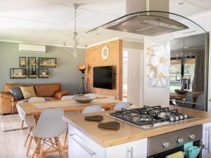a kitchen and living room with a stove at Rest at Chabivin in Stellenbosch