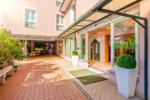 an external view of a building with glass doors at Hotel Palladio in Malcontenta +63 photos