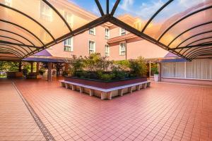 a large building with a courtyard with plants in it at Hotel Palladio in Malcontenta