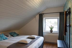 En eller flere senge i et værelse på Eindeloos Asselt