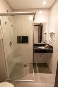 a bathroom with a shower and a sink at Hotel & Pousada Favareto in Florianópolis