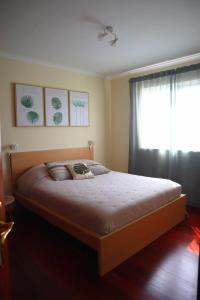 a bedroom with a large bed with a window at Ocean Breeze in Caniço +20 photos