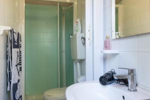 a bathroom with a sink, toilet and shower at Cesenatico Camping Village in Cesenatico