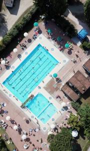 an overhead view of two large swimming pools at Cesenatico Camping Village in Cesenatico