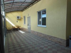 an empty room with a table and a window at Mini-Hotel Svetlana in Slavyansk-na-Kubani