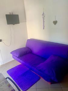 a purple couch in a living room with purple pillows at Villa Lory Krk in Krk