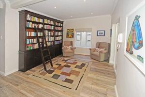 a living room with two bookshelves and a ladder at Cape Town Lock-and-Go House Ideal for your Holiday in Cape Town