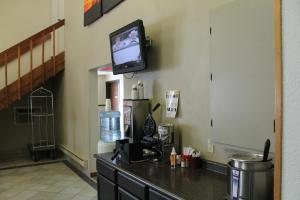 a room with a counter with a tv on the wall at Lone Tree Inn in Sidney