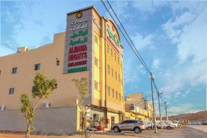 a building with a sign on the side of it at ليالي ألماسية للشقق المخدومة Layali Almasiah serviced apartment in Al Muzāḩimīyah