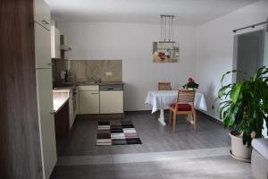 a kitchen with a table and a dining room at EKO-Hof in Mitterlabill