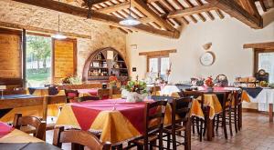 a restaurant with tables and chairs with flowers on them at Agriturismo Santa Serena in Cerreto di Spoleto