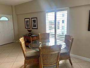 a dining room with a glass table and chairs at Island House Beach Resor 13N in Point O'Rocks
