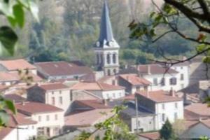 una ciudad con una iglesia y una ciudad con edificios en Chez Fabienne T2, en Le Breuil-sur-Couze