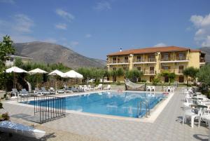 a swimming pool with chairs and a hotel at Porto Lourba in Galaxidi