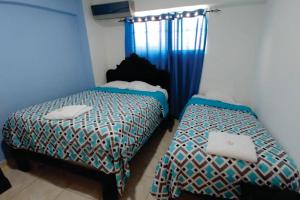 Postel nebo postele na pokoji v ubytování Hostal Magisterial Santo Domingo