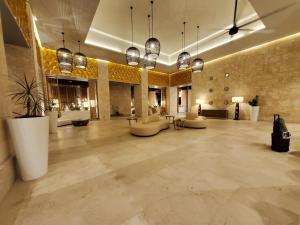 een grote lobby met stoelen en tafels in een gebouw bij Grand Bavaro Princess - All Inclusive in Punta Cana