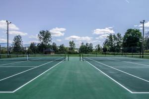 a tennis court with two tennis nets on it at Mountainside Resort V in Stowe