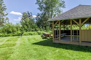 a wooden gazebo with a picnic table in a yard at Mountainside Resort V in Stowe