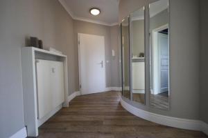 an empty hallway with a large mirror on the wall at Haus-Amber-Mare-Strandtraeumer-9695 in Kühlungsborn