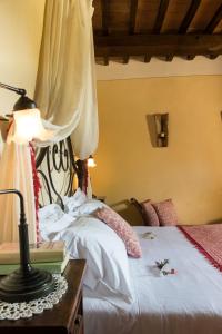 1 dormitorio con 1 cama y 1 mesa con lámpara en Agriturismo Cretaiole, en Pienza