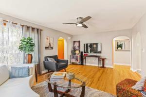 a living room with a white couch and a table at Spacious Family Home with Garage Game Room and Office! in Boise