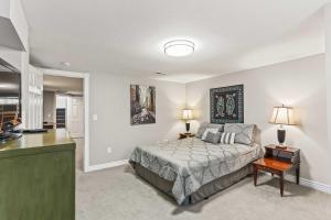 a bedroom with a bed and a table and a kitchen at Spacious Family Home with Garage Game Room and Office! in Boise