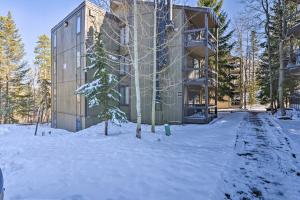 a building in the snow with trees in front of it at quarter Mi to Peak 8 Ski Lift Modern Breck Condo! in Breckenridge