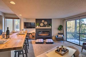 a living room with a table and a fireplace at quarter Mi to Peak 8 Ski Lift Modern Breck Condo! in Breckenridge