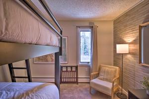 a bedroom with a bunk bed and a chair at quarter Mi to Peak 8 Ski Lift Modern Breck Condo! in Breckenridge