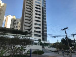 a tall white building with stairs in front of it at Flat no Brookfield Towers in Goiânia